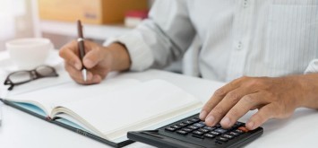 Focused on calculating corporation tax relief using a calculator.