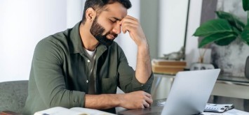 Tired man on laptop