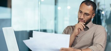 Business man looking at document paper