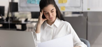 Stressed businesswoman with a document