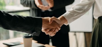 Business people shaking hands during a meeting in office.