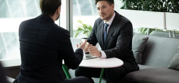 Two businessmen meeting to discuss deal or partnership.