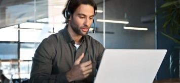 Business man answering a call on the laptop