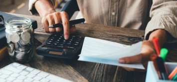 Man working with calculator to calculate numbers.