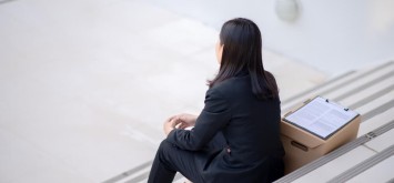 Unemployed woman sitting on the steps
