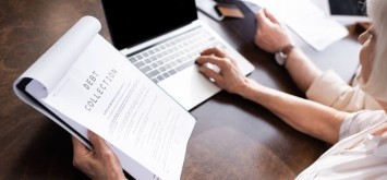 Woman holding a debt collection letter