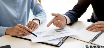 Business man and team analysing financial statement.