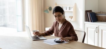 Woman on the calculator at home