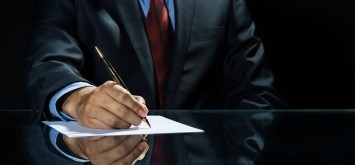 Director signing a loan