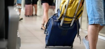 People with suitcases moving aboard