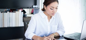 Women looking concerned reading documents.