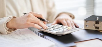 Women using a calculator to calculate quotes