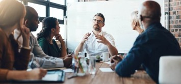 Man, manager and meeting or presentation in boardroom with co-workers for corporate business seminar.