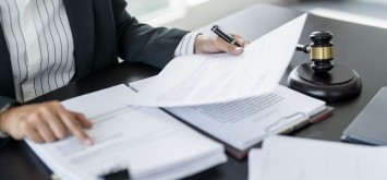 Lawyer businessman working with lawbook in office.