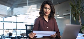 Confident woman looking at document